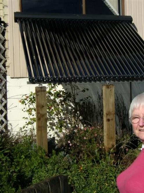 Broad Bay resident Olive Bain admires the solar panel installed in her front yard. Photo by...