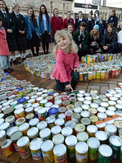 Brooke Cathro (3) adds her contribution to the Presbyterian Support Otago Octacan foodbank appeal...