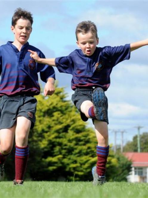 Brothers Josh (11), left,  and Ollie Mackenzie (7) have a kick around at the West Taieri rugby...
