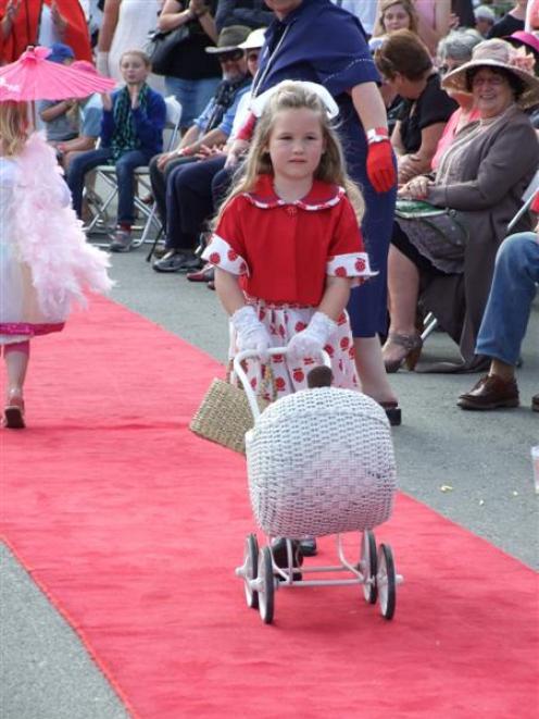 Browning (6), of Invercargill, takes her grandmother's doll carriage along the red carpet during...