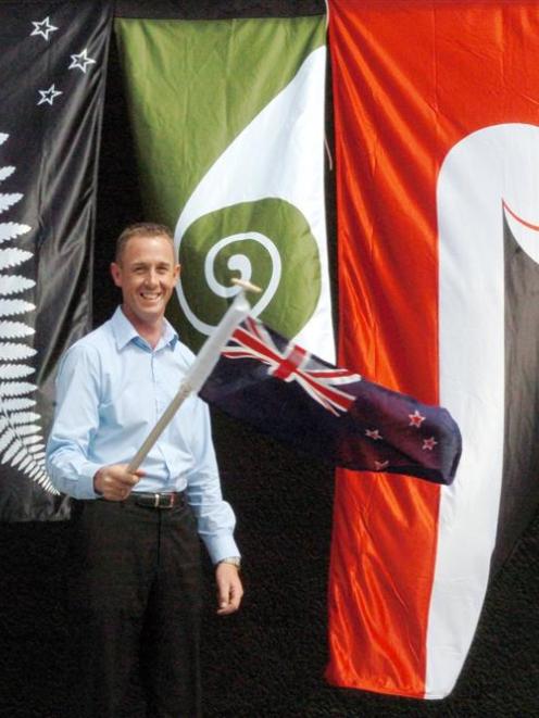 Bruce Adams, of Adams Flags, stands in front of (from left) a version of the silver fern, a...