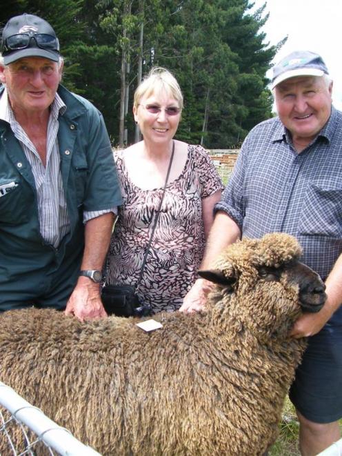 Bruce (left) and Kate McLachlan, from Clarendon, with the ram they paid $1050 for, and vendor...