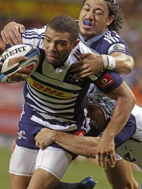 Bryan Habana, left, of the Stormers makes his way to the tryline in the tackle of Ben Lam, of the...