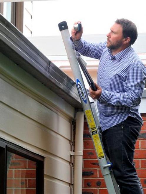 Building surveyor Gwynn Gilmour inspects the roof of a  Castle St flat yesterday. Photo by Craig...