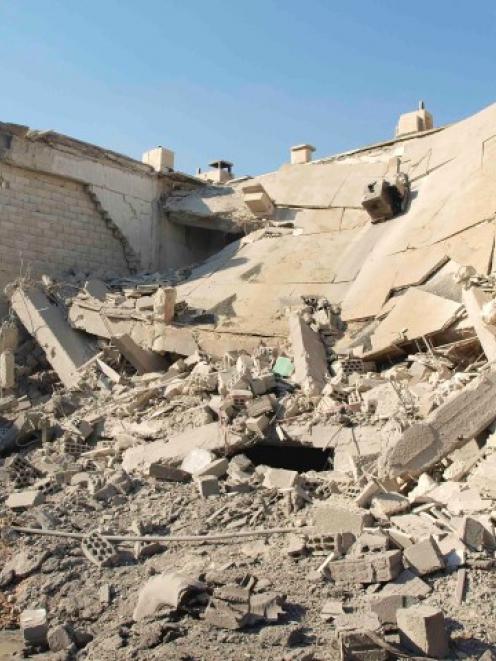 Buildings in Daria near Damascus show damage caused by missiles fired by a Syrian Air Force...