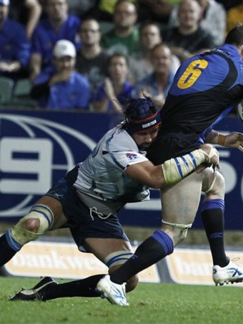 Bulls Victor Matfield of South Africa tackles Richard Brown of the Force during their Super Rugby...