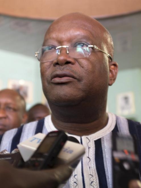 Burkina Faso President Roch Marc Kabore speaks to journalists at the site of an attack in...