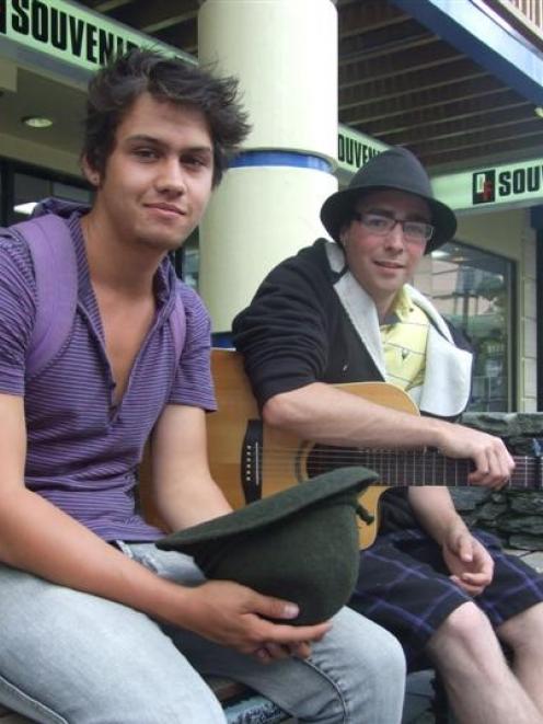 Buskers Dion Birch-Thompson and David Bell make the most of a break in the clouds to play a few...