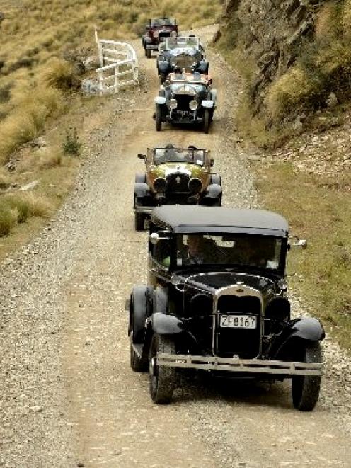 Crossing Danseys Pass yesterday are (front to rear): a 1930 Ford Model A delivery van, a 1927...