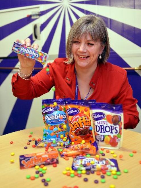 Cadbury Dunedin site manager Judith Mair scatters Pebbles from the redundant cardboard box...