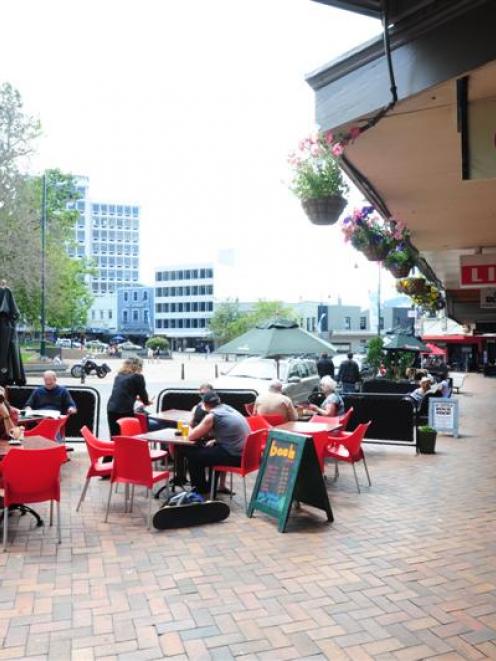 Cafe-goers enjoy alfresco dining in Dunedin's lower Octagon yesterday. Photo by Craig Baxter.