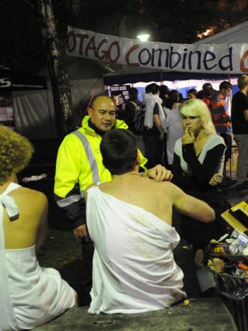 Campus Watch team leader Rea Tasi-Cordtz chats with a group of partying students at a Leith St...
