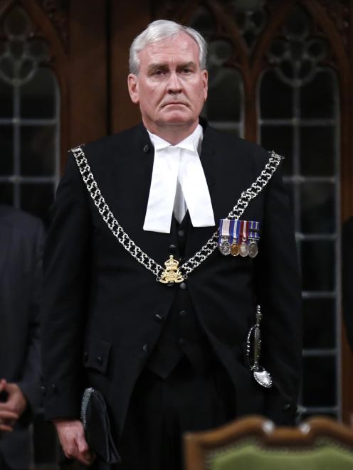 Canada's Sergeant-at-Arms Kevin Vickers is applauded in the House of Commons in Ottawa, in this...