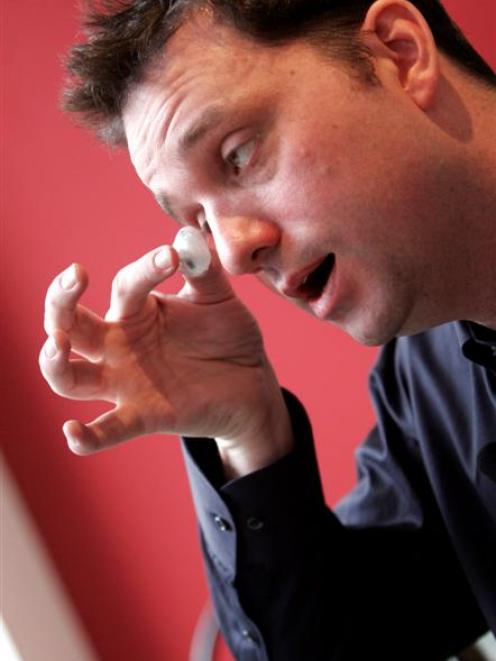 Canadian filmmaker Rob Spence shows his prosthetic eye during an interview with the Associated...