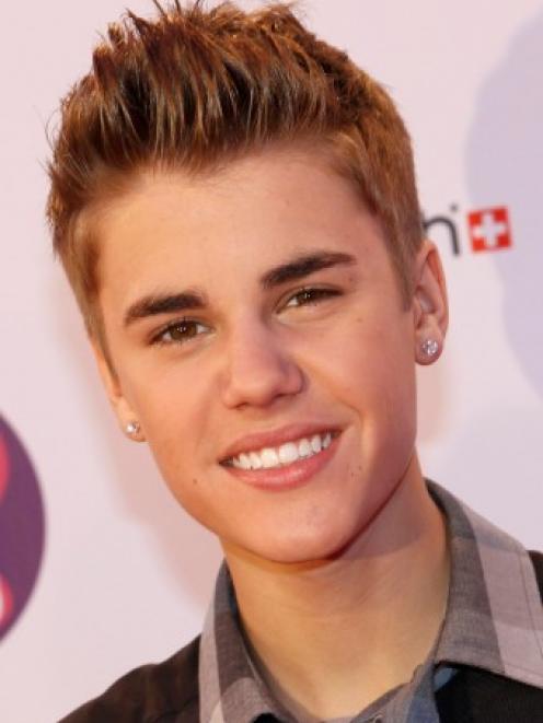 Canadian pop star Justin Bieber poses on arrival on the red carpet at the MTV Europe Music Awards...