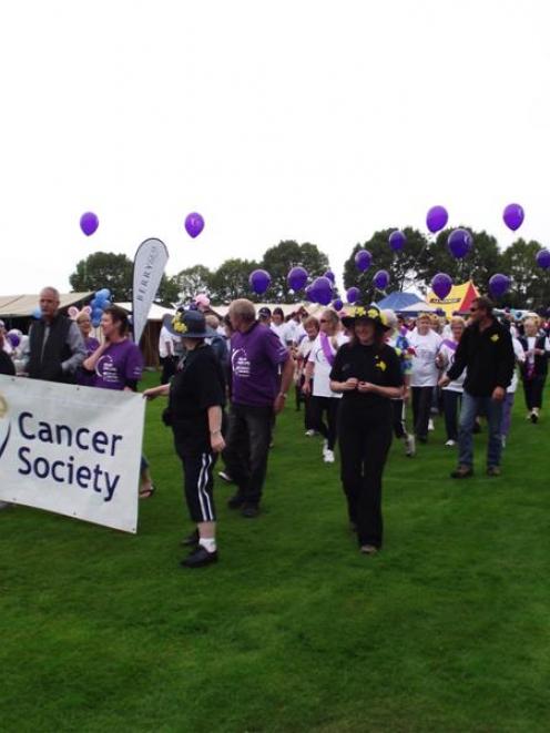 Cancer sufferers, their families and friends lead the first lap of honour