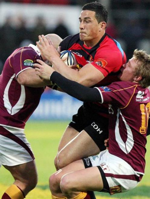 Canterbury's Sonny Bill Williams is wrapped up by the Southland defence. Credit:NZPA / Dianne...