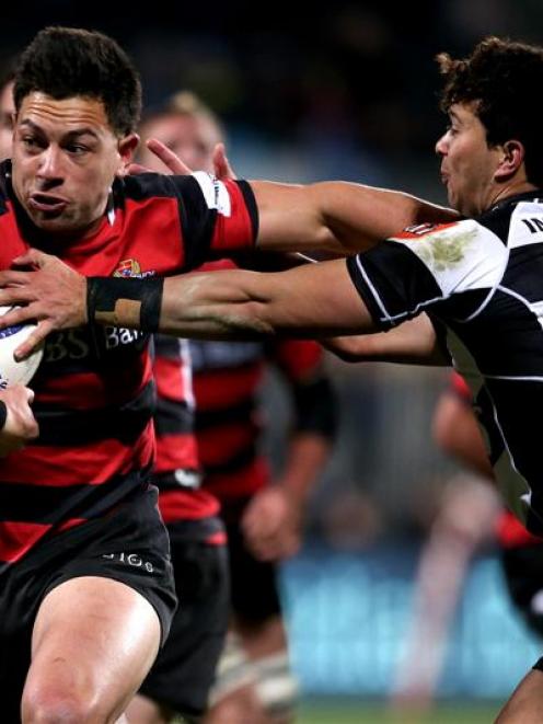 Canterbury second five Rob Thompson fends off a tackler in an outstanding performance in their...