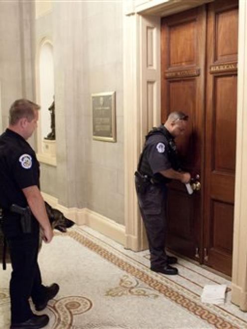 Capitol police and their sniffer dog are outside the office of the Senate Minority Leader,...