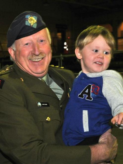 Captain Kevin Weir shares a moment with grandson Dillion  (3) after being surprised with a cadet...