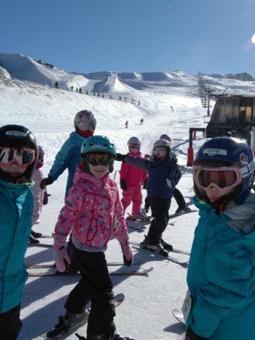 Cardrona Alpine Resort instructors Dee Hameed (left, in red) and Charlie Gardner (right) guide...