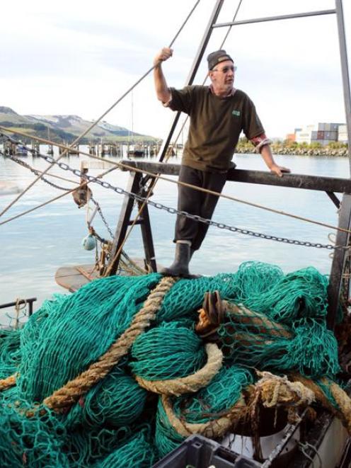 Careys Bay fisherman Les Poulsen with the 100m-long net he hauled up near Blueskin Bay. Photo by...