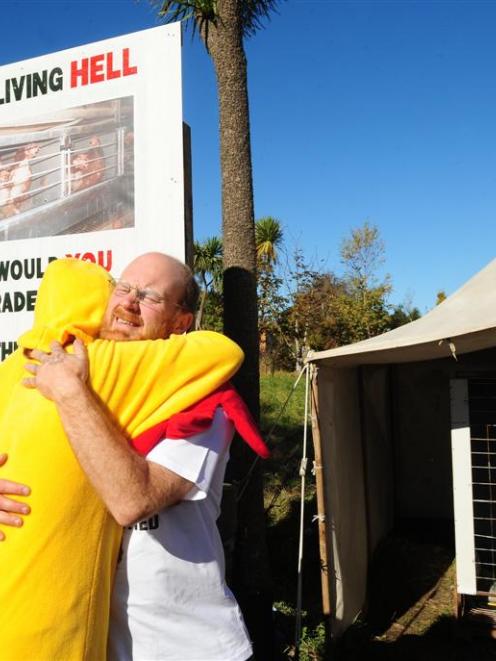 Carl Scott (right) is congratulated by Save Animals from Exploitation Dunedin volunteer co...