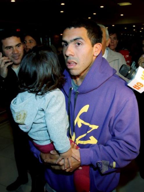 Carlos Tevez with one of his daughters in Buenos Aires earlier this month. Tevez will face...
