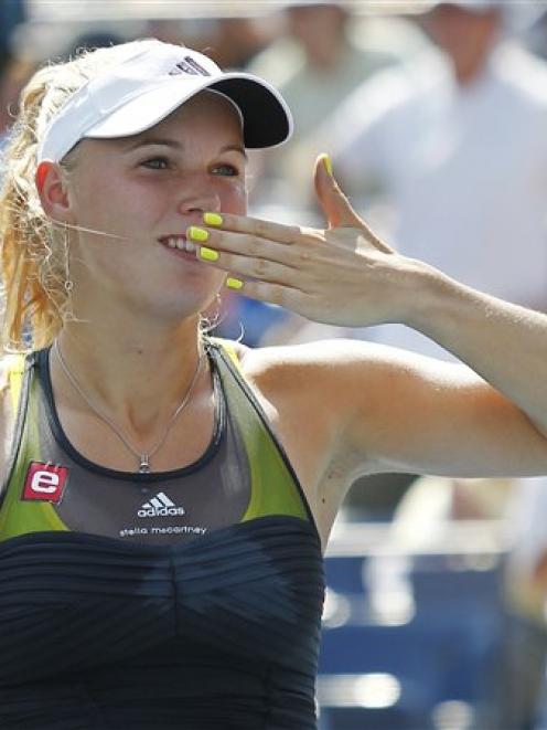 Caroline Wozniacki of Denmark blows kisses to the crowd after she defeated Chang Kai-chen of...