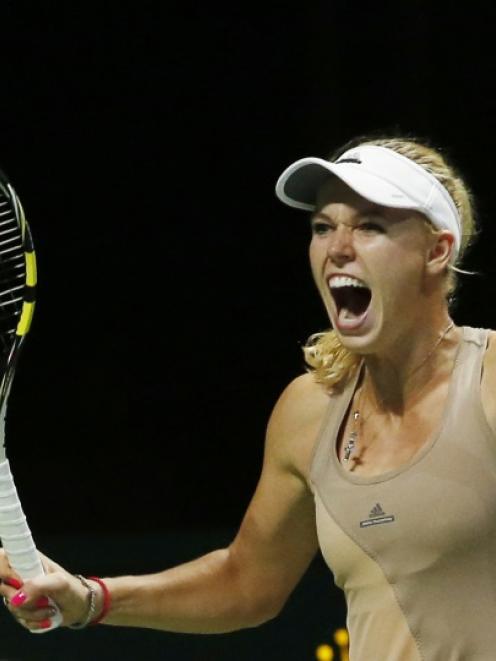 Caroline Wozniacki of Denmark celebrates her win over Maria Sharapova of Russia during their WTA...