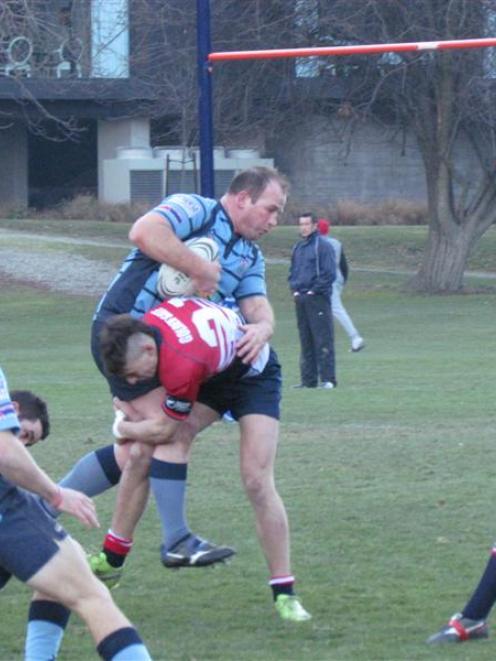 Carrick McLellan, of the Wakatipu Premiers, is tackled by a Cromwell player during Saturday's ...