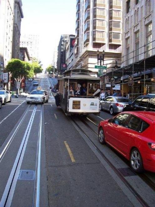Cars and cable cars vie for their own space on a San Francisco street, this one reminiscent of...