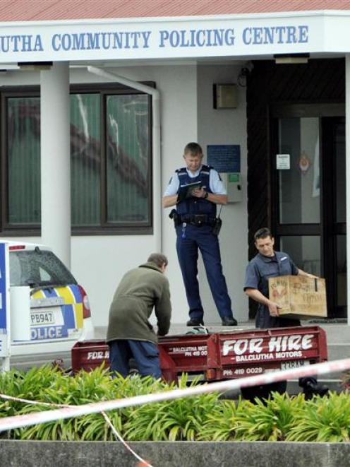 Cartons of gelignite are removed from the steps of the Balclutha Police Station.