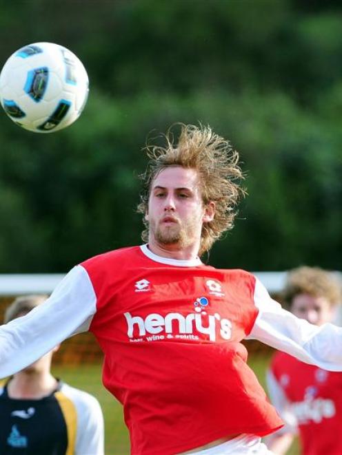 Caversham player Seamus Ryder jumps to meet the ball during his team's Chatham Cup match against...