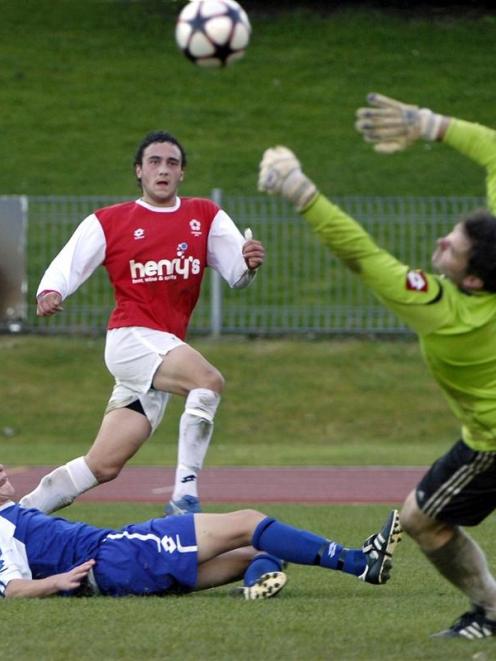 Caversham striker Tom Jackson (centre) scores one of his three goals in his side's 8-0 win...