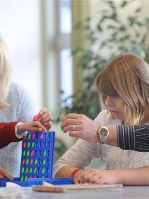 Celebrating Autism Day are, from left, Erin Halliday (15), teacher Barbara Guest and Kristal...