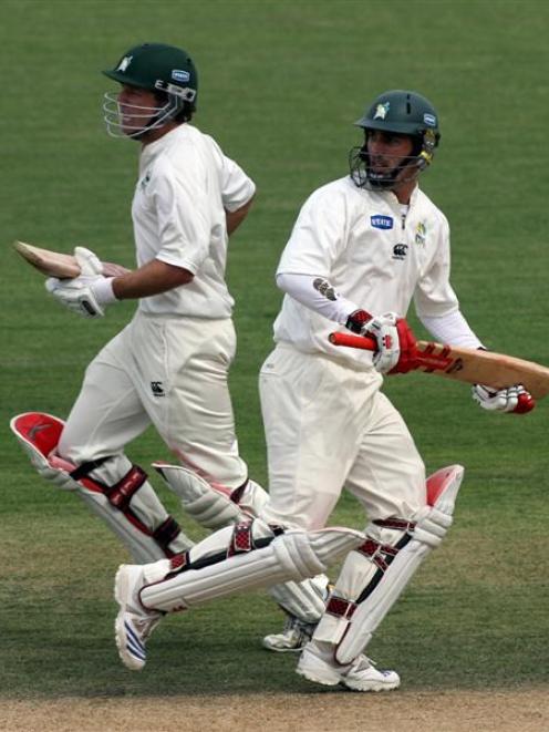 Central Districts batsmen Brad Patton (left) and Mathew Sinclair cross while taking a run on...