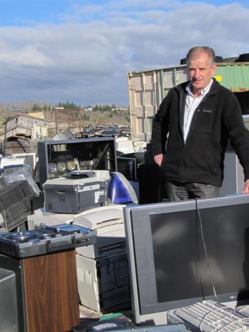Central Otago WasteBusters manager Brian Fitzgerald with some of the old television sets at the...