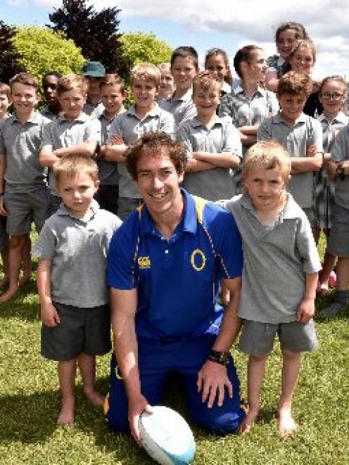 Central Otago youth rugby co-ordinator Warren Kearney with St Gerard's pupils Charlie Tait (5) ...
