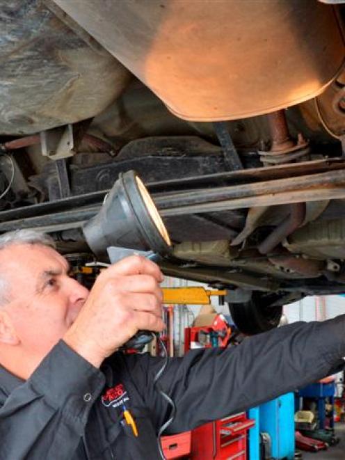 Centre City Auto Repairs owner Stephen Fraser inspects a vehicle for a warrant of fitness in...