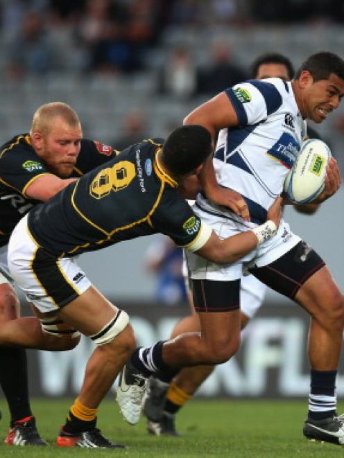 Charles Piutatu of Auckland is tackled by Ardie Savea of Wellington during their ITM Cup match at...
