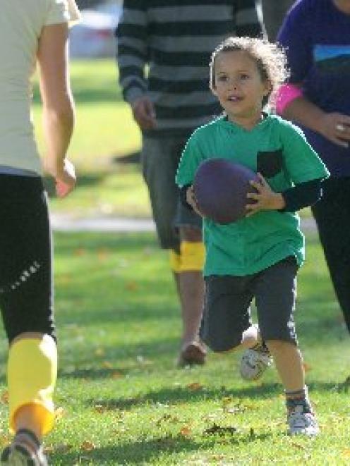 Charlie Jackson (4), of Dunedin, plays ti uru with adults at the Otago Museum Reserve during  the...