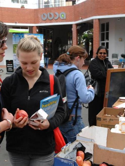 Checking out the information stall and giveaways at the Otago University Students Association...