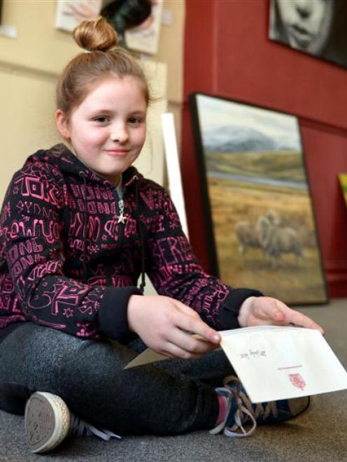 Chelsea-Blue Sinclair holds the thank-you letter she received from Buckingham Palace after...