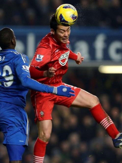 Chelsea's Demba Ba (L) challenges Southampton's Maya Yoshida during their English Premier League...