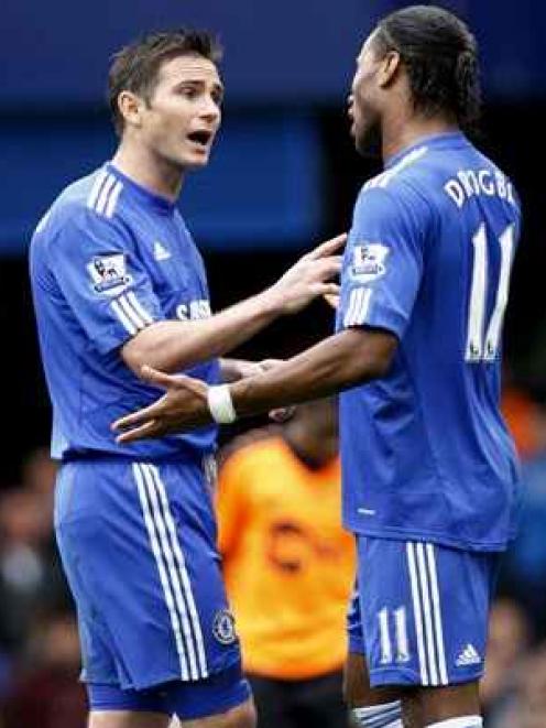 Chelsea's Frank Lampard, left, talks to Didier Drogba after he scored a penalty goal against...