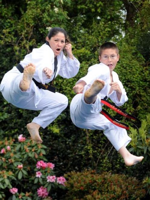 Cherie (left) and Ricky Jackson demonstrate some taekwondo moves at their home in Abbotsford...
