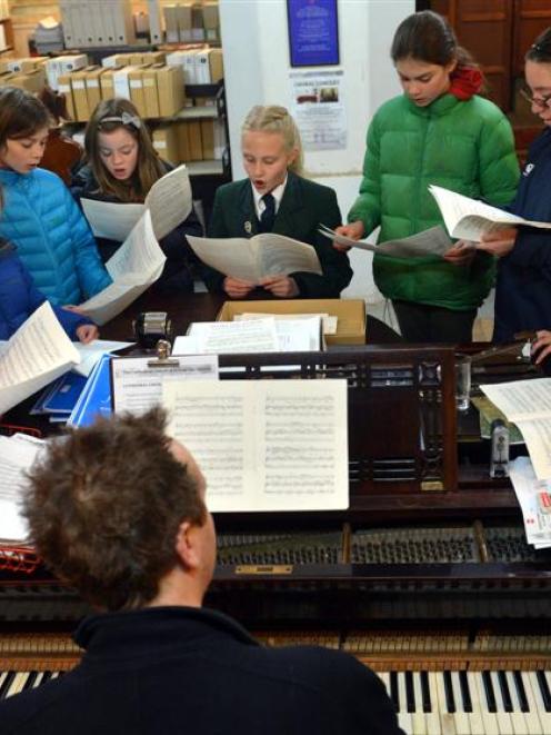 Children in the St Paul's Cathedral choir rehearse with director of music George Chittenden in...