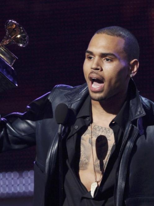 Chris Brown accepts the award for best R&B album for "F.A.M.E." at the Grammy Awards earlier this...