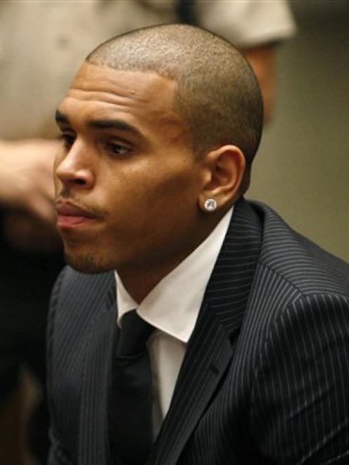 Chris Brown sits before the judge during his sentencing for assaulting his girlfriend Rihanna, at...